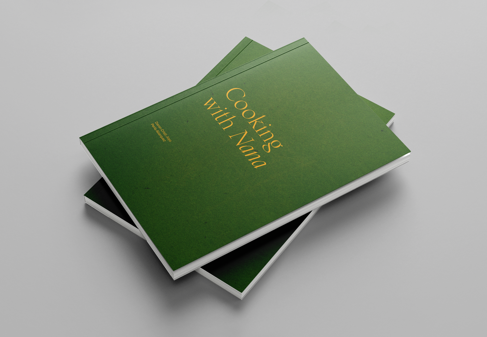 Two books with a green cover stacked on top of each other.